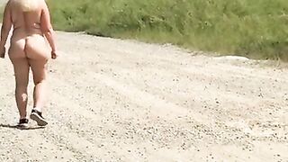 Wife outside naked – machinery in background.