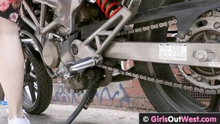 Hot busty blonde lesbian gets licked next to her motorbike
