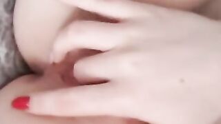 Naked beauty with perfect breasts masturbates. Close-up.