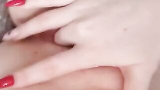 Naked beauty with perfect breasts masturbates. Close-up.