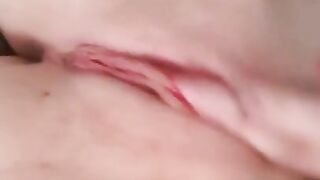 Naked beauty with perfect breasts masturbates. Close-up.