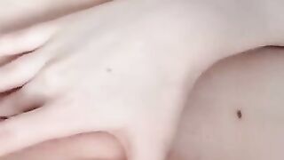 Naked beauty with perfect breasts masturbates. Close-up.