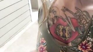 Tattooed girl in dress teases