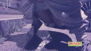 Girl alone at night in a parking lot lowers her pants in public to piss