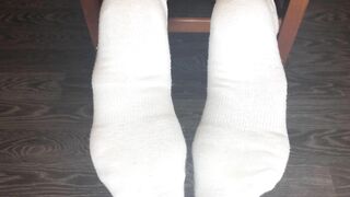 STUDENT GIRL SHOWS WHITE SOCKS AND FEET AFTER STUDYING.