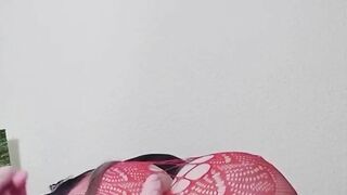 Susi on the bed. She has a sexy fishnet dress on fucking with toy