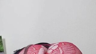 Susi on the bed. She has a sexy fishnet dress on fucking with toy