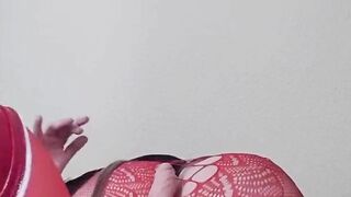 Susi on the bed. She has a sexy fishnet dress on fucking with toy