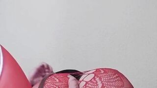 Susi on the bed. She has a sexy fishnet dress on fucking with toy