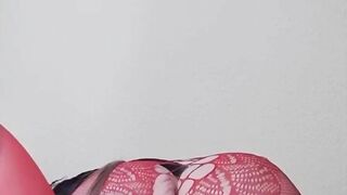 Susi on the bed. She has a sexy fishnet dress on fucking with toy