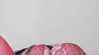 Susi on the bed. She has a sexy fishnet dress on fucking with toy