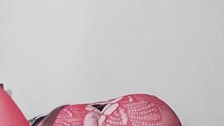 Susi on the bed. She has a sexy fishnet dress on fucking with toy