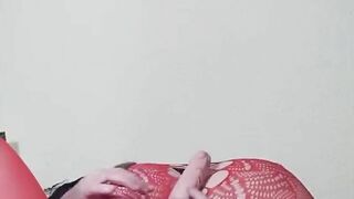 Susi on the bed. She has a sexy fishnet dress on fucking with toy