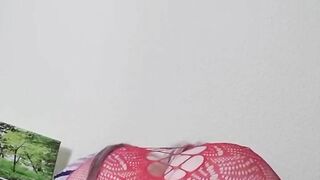 Susi on the bed. She has a sexy fishnet dress on fucking with toy