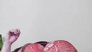 Susi on the bed. She has a sexy fishnet dress on fucking with toy