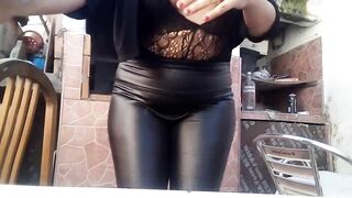 The milf neighbor on her terrace wearing latex clothes