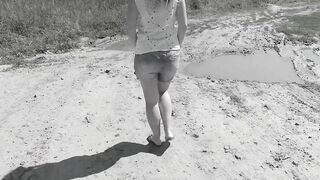 Slim MILF pissing on the side of the road