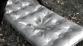 Pissing on an air mattress by a milf with a hairy pussy and big natural tits.